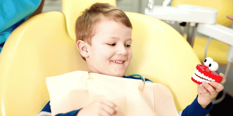 Smiling young boy in the dental chair